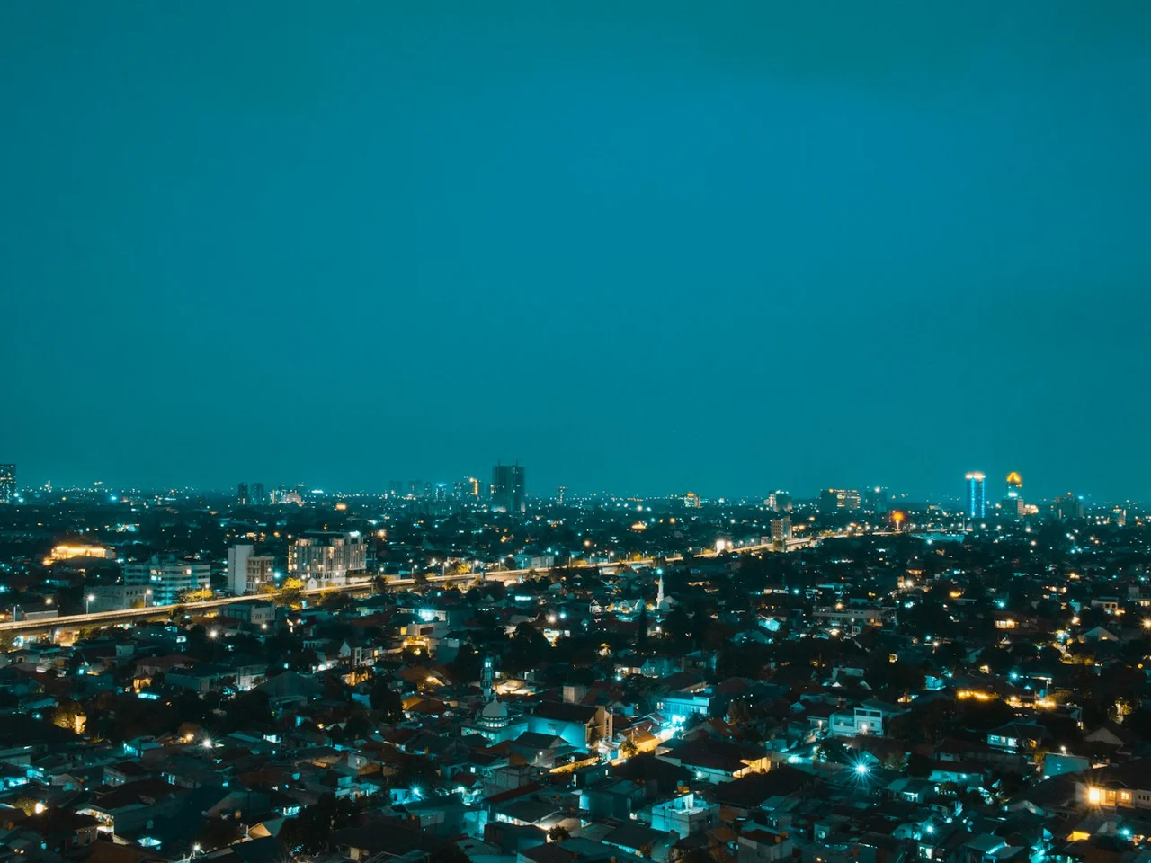Buildings and illuminated streets in Jakarta at night, representing building intelligence.