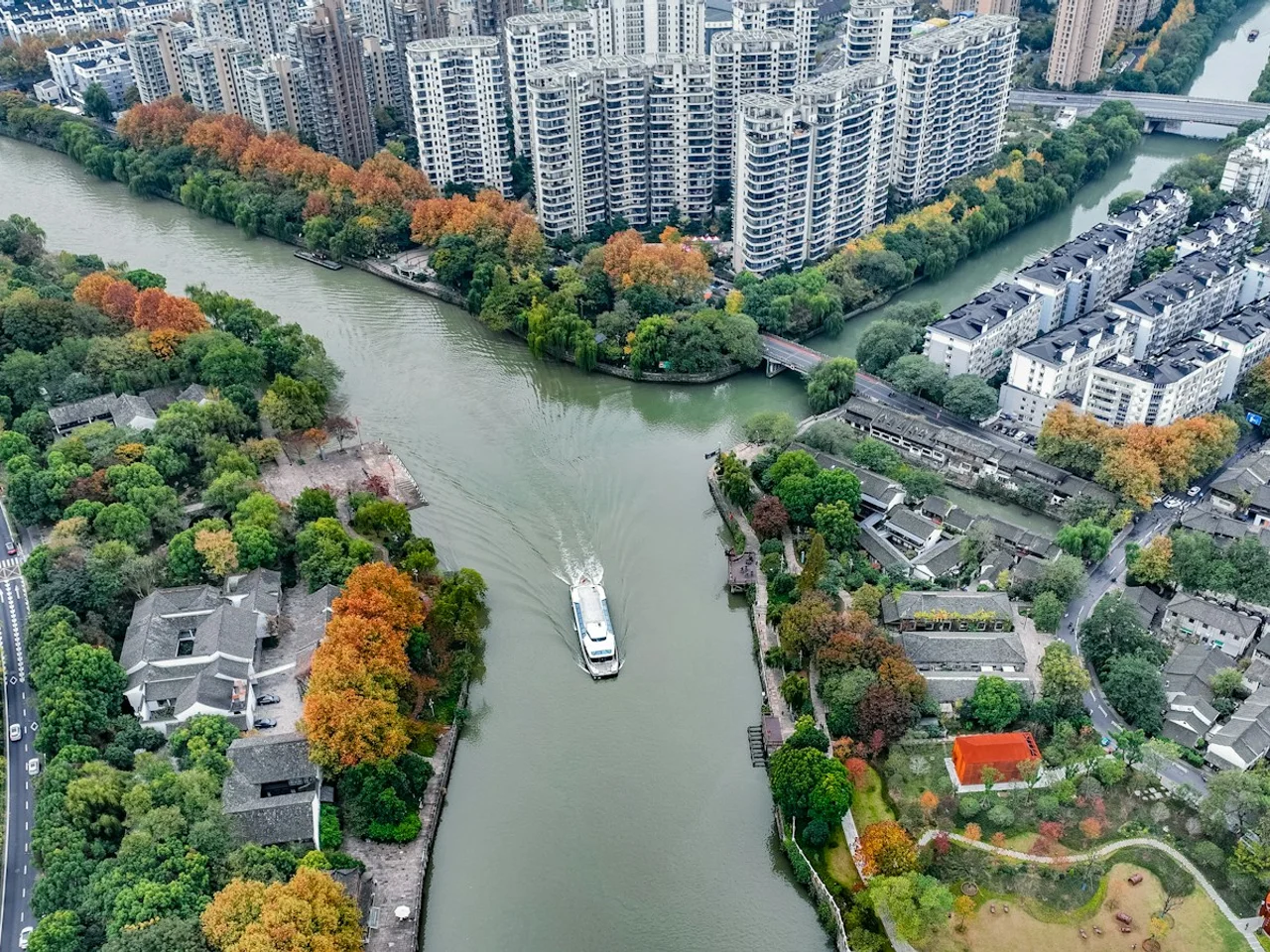 Aerial view of connected rivers and urban neighborhoods in Hangzhou, representing hydrological analysis.